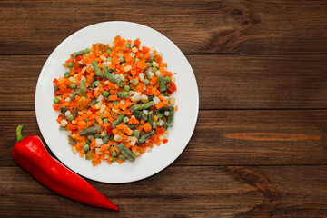 Frozen vegetables carrots, peas, beans in a plate.
