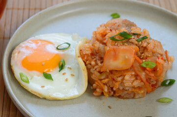 a plate of kimchi fried rice with fried egg