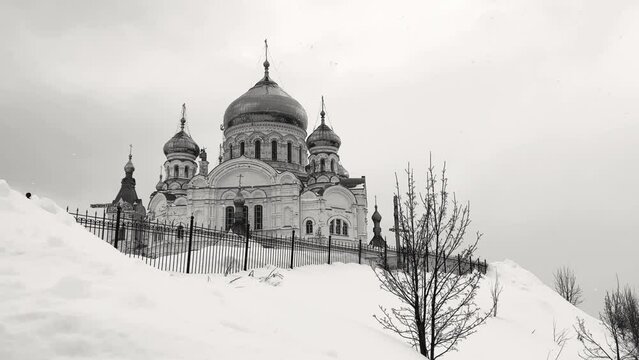 Belogorsky St. Nicholas Orthodox Missionary Monastery. Russia, Perm Krai, Belaya Gora. The temple on the hill in winter. Monastery on the background of snow. 4K