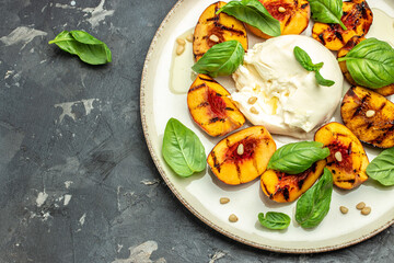 Burrata cheese and grilled peaches with rose wine. top view. place for text