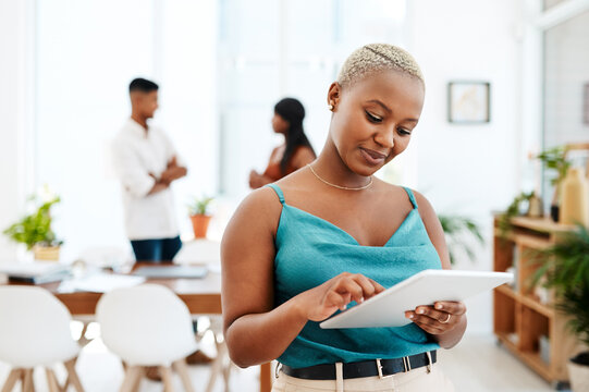 The device favoured by go getters everywhere. a young businesswoman using a digital tablet in a modern office.