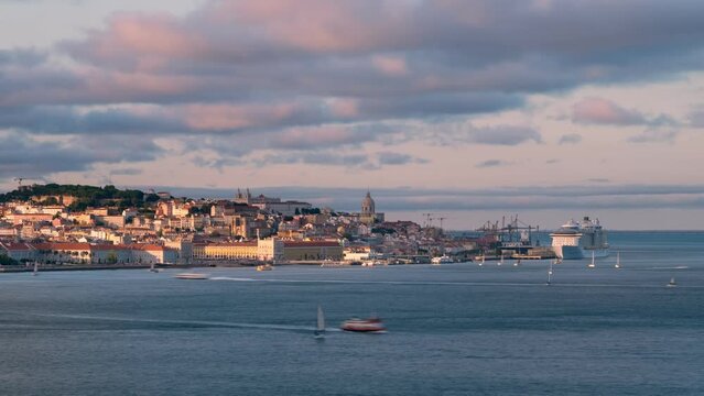 Time-lapse of Lisbon view over Tagus river from Almada with yachts and ferry boats on sunset. Lisbon, Portugal