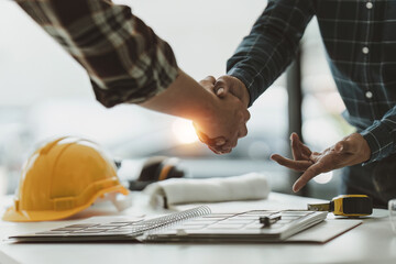 Foreman or Civil engineer handshake making modern construction. industry professional team and...