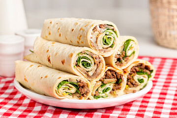 Piadina or piada, thin Italian flatbread rollups, typically prepared in the Romagna, rolled with...