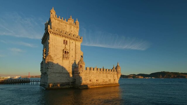 Belem Tower or Tower of St Vincent - famous tourist landmark of Lisboa and tourism attraction - on the bank of the Tagus River (Tejo) with tourist boats on sunset. Lisbon, Portugal