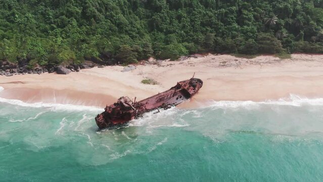 an abandoned and rusty shipwreck stranded on a beach