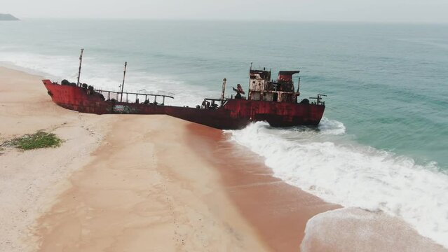 a rusty shipwreck abandoned at the west african coast in Robertsport, Liberia