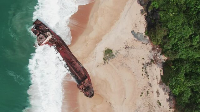 top-down perspective on to a shipwreck that is abandoned at the west african coast in Robertsport, Liberia