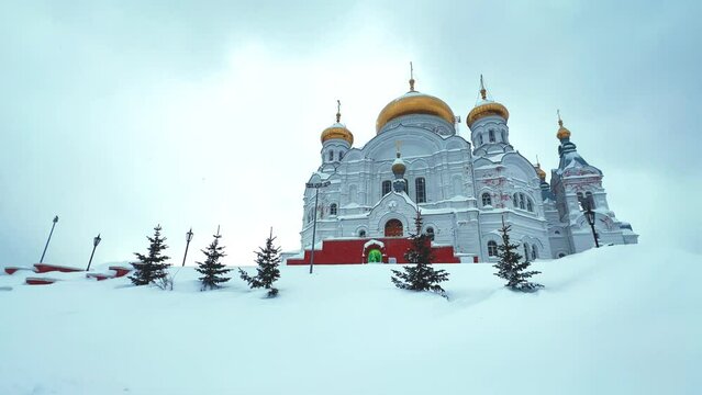 Belogorsky St. Nicholas Orthodox Missionary Monastery. Russia, Perm Krai, Belaya Gora. The temple on the hill in winter. Monastery on the background of snow. 4K