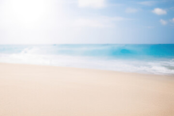 Fototapeta na wymiar blurred beach background with sunrays, summer sandy empty beach