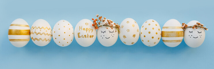 Easter background. Easter golden decorated eggs on blue background. Minimal easter concept. Flat Lay of Golden Easter Eggs