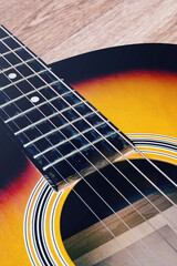 Obraz premium Acoustic guitar on a wooden background closeup