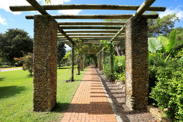 Vine pegola made of brick and wood at Fairchild Tropical Botanic Gardens.  Fairchild is a world premier public tropical garden in Miami, Florida, USA. 