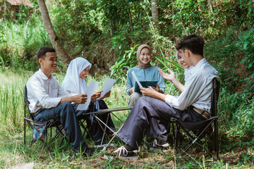 everyone listened as one of the students gave a presentation during an outdoor class