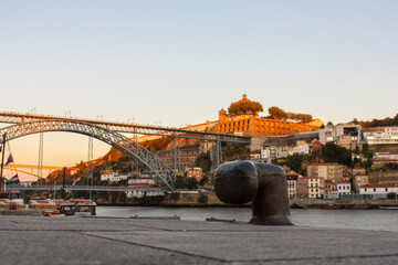 General view of the Luis I Bridge in Porto, Portugal, over the Douro River, with the port in the foreground