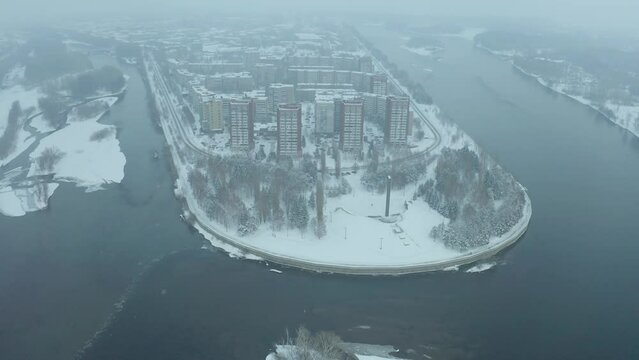 flying a drone over the central place of the city of Ust Kamenogorsk, strelka district, winter cloudy weather, city view