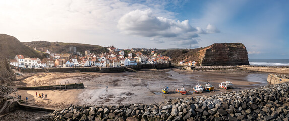 Aerial panorama view of the North Yorkshire coastal fishing village of Staithes - obrazy, fototapety, plakaty