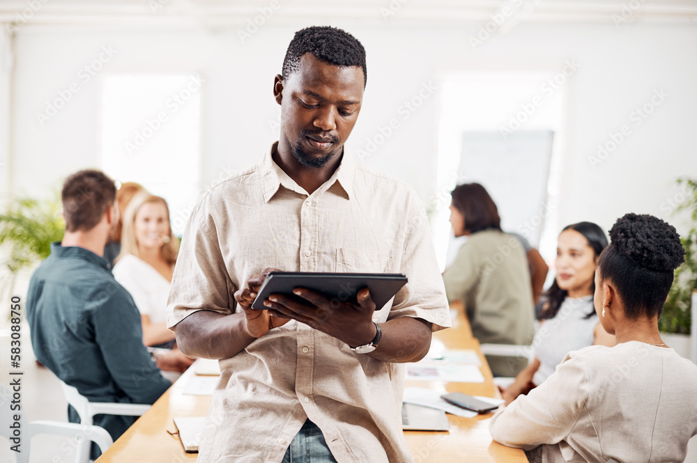 Aufkleber driving innovation into all that he does. a young businessman using a digital tablet in an office wi