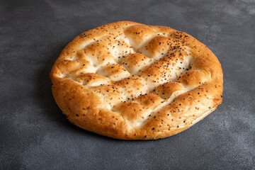 Traditional Ramadan pita on black background.Holy bread for Muslims

