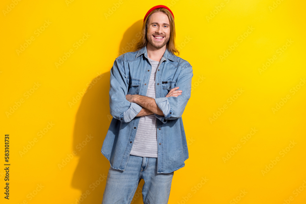 Canvas Prints Photo of candid sincere guy with long hairstyle dressed jeans shirt holding arms folded smiling isolated on yellow color background