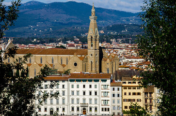 Great view of Santa Maria Novella between trees in Florence, Italy, stock photo
