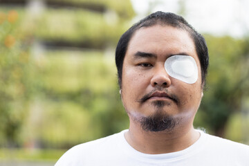 Asian middle-aged man patient with eye patch, eye sight impair