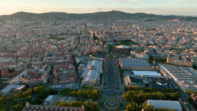 Aerial panning right drone video of the city of Barcelona at sunset. Montju&iuml;c, Anella Ol&iacute;mpica.
