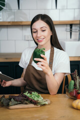 Woman preparing healthy food in her kitchen.