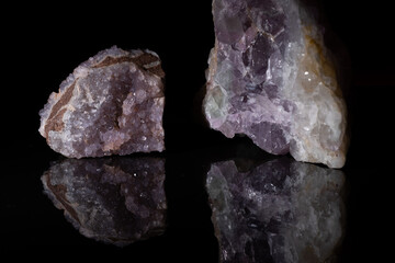 Amethyst mineral with crystals on a black background.