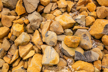 Background with dark stones with yellowish dust