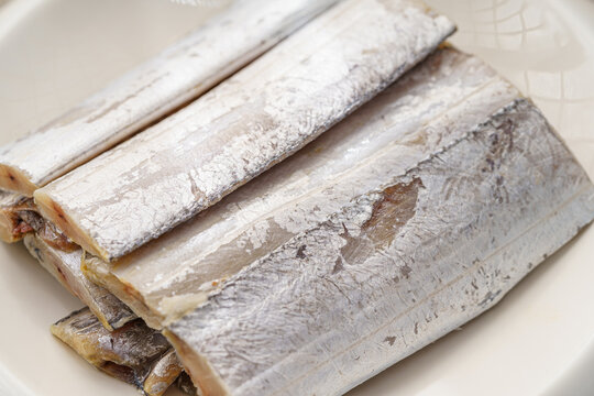 Sliced saury fish on a simple background