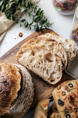 Artisan Batard Sourdough healthy Bread with leaf scoring. Open crumb high hydration Sourdough bread set on white table. - 583112145