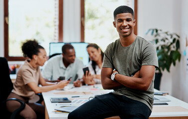 Were about to change this industry for the better. Portrait of a confident young businessman with his team having a meeting in the background.