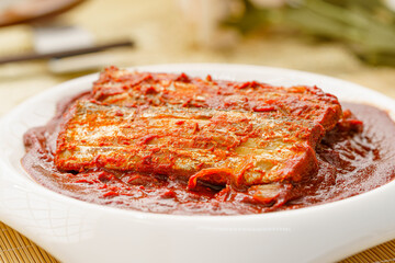 Korean style braised hairtail on a simple background