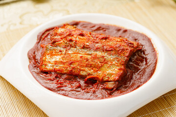 Korean style braised hairtail on a simple background