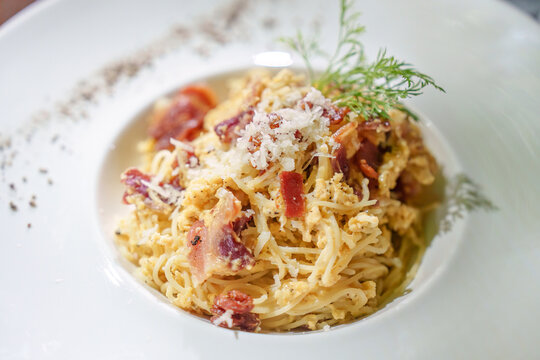 Bacon spaghetti carbonara parmesan cheese menu in white dish