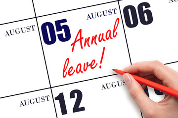 5th day of August. Hand writing the text ANNUAL LEAVE and drawing the sun on the calendar date August 5. Save the date. Time for the holidays. vacation calendar. Summer month, day of the year.