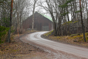 gravel road beside old barn a misty day