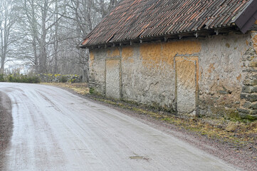 gravel road beside old barn a misty day