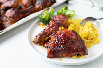 Glazed chicken with honey barbecue sauce, pilau rice and broccoli on a plate