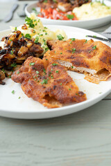 Pork schnitzel with fried onions, mashed potatoes on a plate. Traditional german dinner or lunch