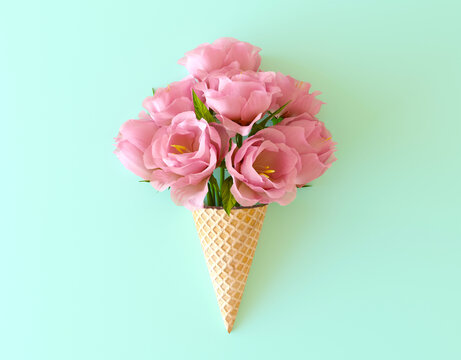 Summer flowers in the waffle cone. Pink flower ice cream on flat lay pastel table, top view. 3d render illustration. Creative still life of an ice cream waffle cone with flowers, summer idea.