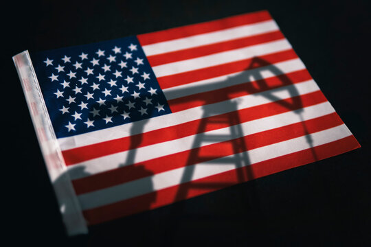 oil industry of USA . Oil rigs on the background of the United States of America flag. Mining and oil export. trading on global fuel market. Fuel industry concept.