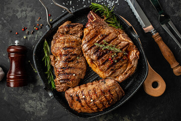 three beef steaks with grilled spices on a stone background. Restaurant menu, dieting, cookbook...