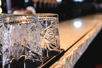Washed whiskey glasses on the bar