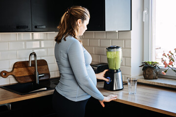 Green Smoothies Recipes For Pregnancy and Postpartum, Prenatal Nutrition. Pregnant woman preparing...