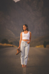 Young Fashionable Woman Posing on a Deserted Road