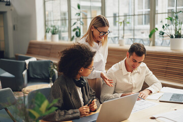 Businesspeople working together on new project in modern office. Teamwork concept