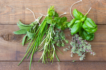 Freshly harvested herbs on wooden background