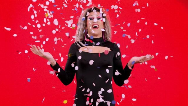 Drag queen person surrounded by confetti flying in the air
